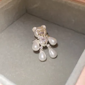 Close-up of elegant bear-shaped ring with lustrous pearls and a heart-shaped zircon