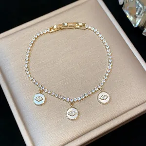 Detailed view of this 18k gold plated bracelet featuring zircon eye charms and chain