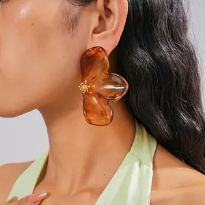 Exquisite large amber resin flower petal stud earrings with translucent texture.