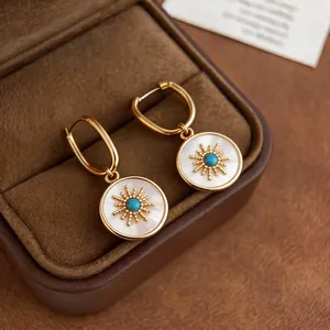 Elegant 24k gold plated round earrings with mother of pearl and sun motif design