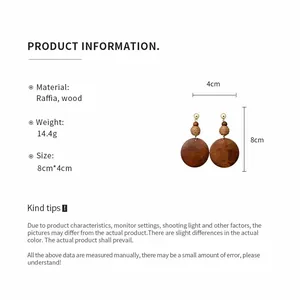 Detailed view of handmade raffia and wood round earrings with size and weight info