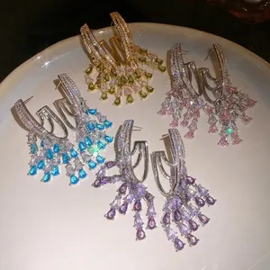 Elegant 18k gold plated cubic zirconia teardrop tassel earrings displayed in vibrant colors
