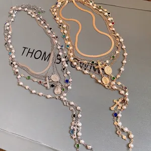 Elegant multi-layered pearl necklace with colorful rhinestones and cross charms