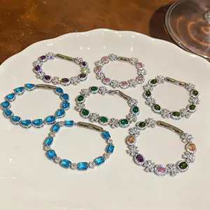Exquisite colorful cubic zirconia flower bracelets displayed on a ceramic plate
