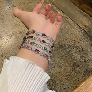 Detail view of colorful zircon flower bracelets on wrist with sparkling oval stones