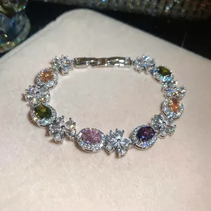 Detail view of a luxury colorful zircon bracelet featuring oval stones and flower designs