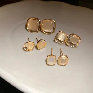 Vintage-style cat eye stone earrings set with gold-tone finish and rhinestone details