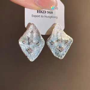 Elegant silver-toned wrinkled rhombic earrings with clear zircon stones for a fresh vacation style.