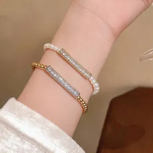 Elegant pearl and gold bead bracelet set with pavé-set zircon rectangular bars