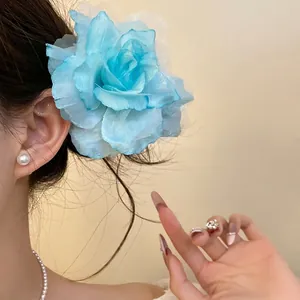 Ethereal light blue mesh fabric flower hair clip on model for spring vacation styling