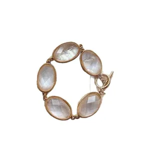 Elegant gold-tone bracelet featuring five oval faceted iridescent stones with a toggle clasp