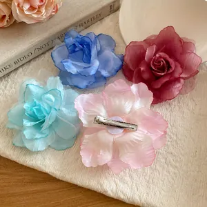 Close-up detail of multi-color fabric mesh flower hair clips with duckbill clip back view