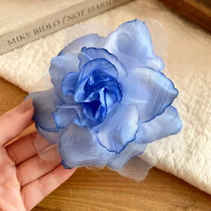 Close-up of an elegant blue fabric rose hair clip featuring delicate gauze petals for hair