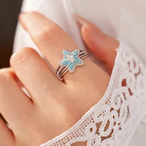 Elegant silver star-shaped ring with blue pavé stones and micro cross detail