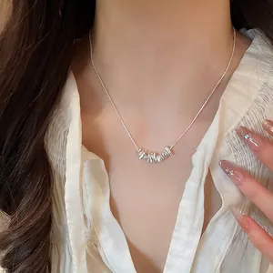 Minimalist silver irregular bead pendant necklace worn on neck