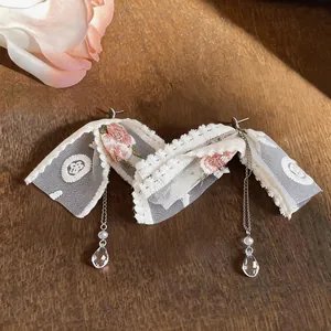 Detailed macro view of elegant lace flower tassel earrings with crystal water drop charms