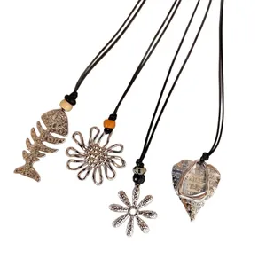 Set of retro ethnic necklaces with fish bone, floral and heart pendants on black cords
