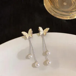 Elegant butterfly drop earrings with long silver tassels and delicate white faux pearls.