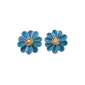 Elegant blue enamel flower stud earrings with gold plating and a sparkling center crystal