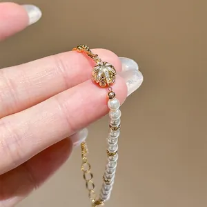 Close-up of elegant 18K gold plated zircon and white pearl adjustable bracelet