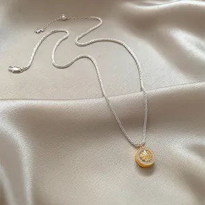 Detailed view of an elegant gold necklace with a sparkling zircon eight-pointed star pendant