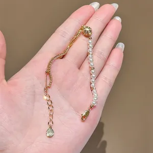 Detailed view of gold-plated bracelet with delicate pearls and sparkling zircon accents.