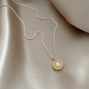 Close-up of eight-pointed star necklace with sparkling zircon on satin fabric.