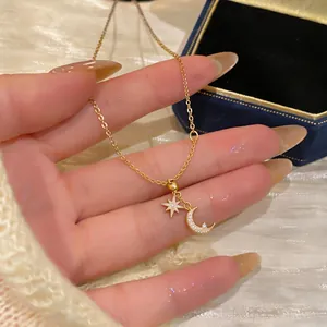 Detailed macro view of 18k gold plated necklace featuring zircon moon and star charms