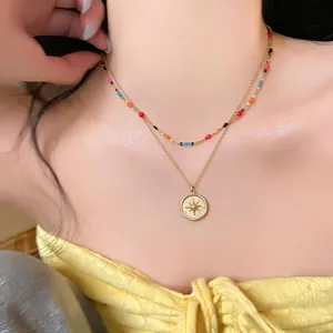 Close-up of double-layer gold necklace with colorful enamel beads and star pendant