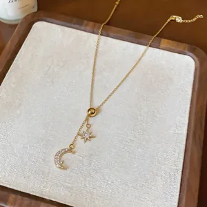 Detailed close-up of an 18k gold plated necklace featuring zircon moon and star pendants