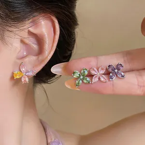 Detail shot showing four multi-colored butterfly stud earrings with marquise-cut zircons.