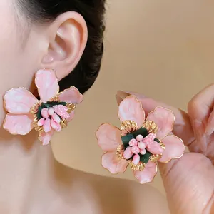 Elegant oversized pink enamel flower stud earrings with gold metallic edges for women
