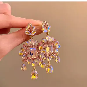 Detail view of luxurious rhinestone chandelier earrings with square and teardrop crystals