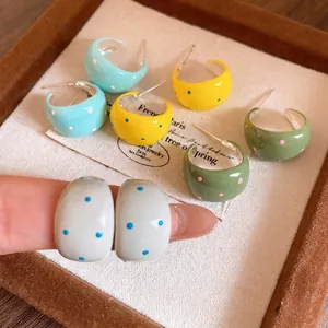 Summer style colorful polka dot C-shape drip oil earrings with silver needles displayed on a tray