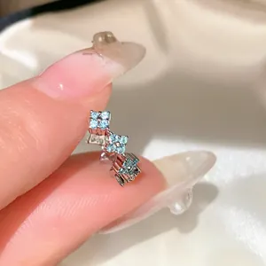 Detailed close-up of zircon flower stud earring with shimmering light blue stones