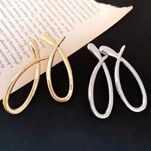 Elegant minimalist hollowed out cross metal stud earrings in gold and silver finishes