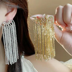 Close-up detailed view of elegant gold and silver firework glass tassel earrings for women