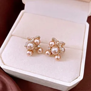 Elegant champagne pearl stud earrings with zircon bow-knot design presented in a luxury gift box