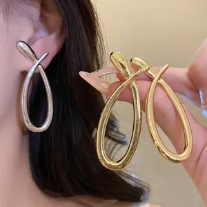 Elegant cross hollow teardrop stud earrings available in shiny gold and silver finishes