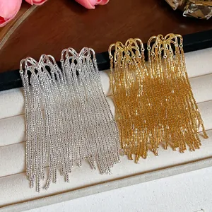 Close-up detail of luxury fireworks glass bead tassel drop earrings in gold and silver