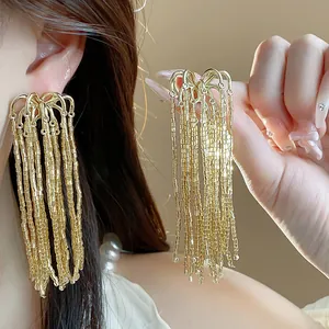 Close-up detail of elegant gold fireworks glass tassel earrings for a luxury look