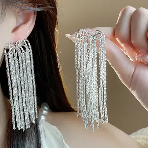 Detailed view of elegant silver fringe earrings with shimmering firework tassel design