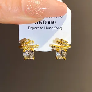 Detailed view of elegant gold-plated stud earrings with sparkling round central zircon