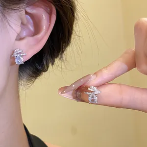 Macro view of exquisite silver needle zircon stud earrings with unique winding design