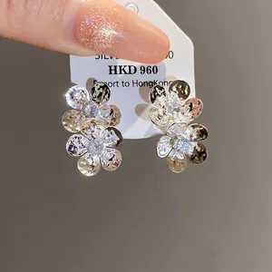 Elegant vintage silver stud earrings featuring layered flower design with zircon stones