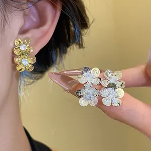 Vintage flower stud earrings featuring sparkling zirconia in gold and silver finishes
