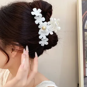 Elegant white fabric flower hair claw clip with central pearl for back of head styling.