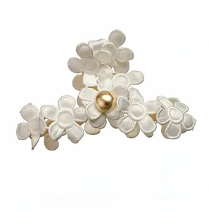Elegant white fabric flower hair claw clip featuring a central golden pearl accent
