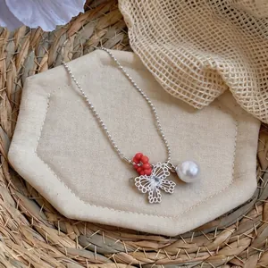 Elegant hollow butterfly necklace with zircon and pearl on a bead chain.