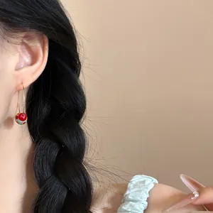 Detailed close-up showing a vibrant dopamine style bead hoop earring worn on an ear.